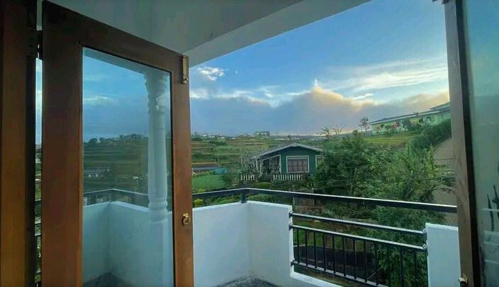 Misty hill and tea-terrace views from a Zonova Mist balcony in Nuwara Eliya